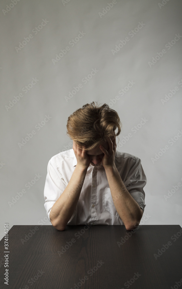 Tired young man. Overtime and fatigue concept. Tired young man. Overtime and fatigue concept.