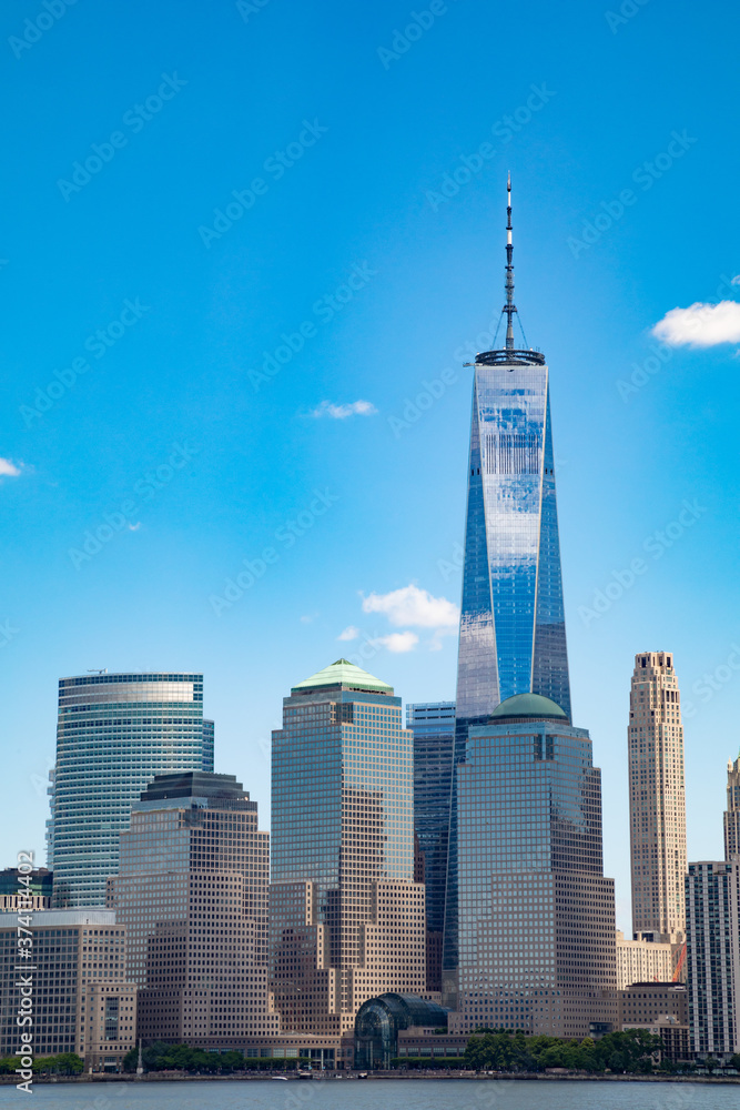 Vertical image of the lower Manhattan skyline on a clear blue day. 