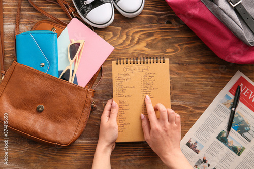 Woman making check-list of ...