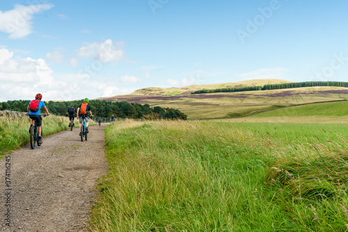 Few cyclist cycling in nature. Mountain bike outdoor trail in scottish highlands photo