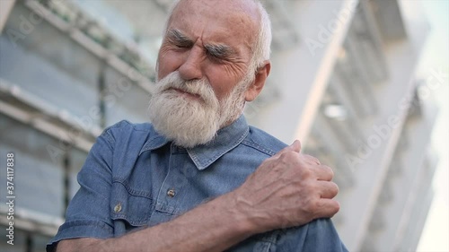 Wallpaper Mural Grey haired old man feeling shoulder pain, inflammation of joint, muscle injury Torontodigital.ca