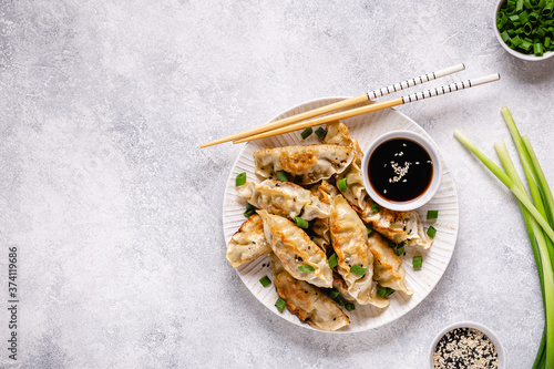 Fried dumplings gyoza with soy sauce, and chopsticks. photo