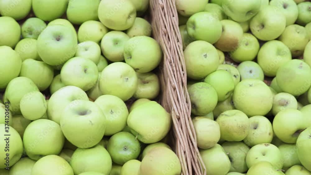 green apples on boxes in supermarket. Apples being sold at public market. Organic food green apples on boxes in supermarket. Apples being sold at public market. Organic food