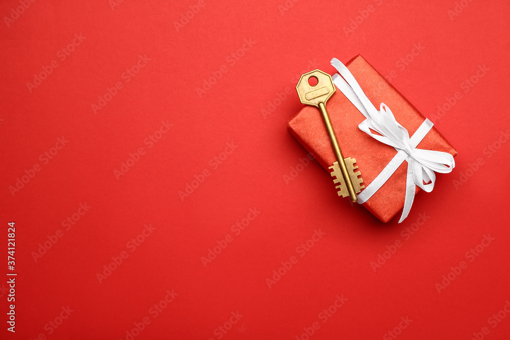 Gift box with key on color background Gift box with key on color background