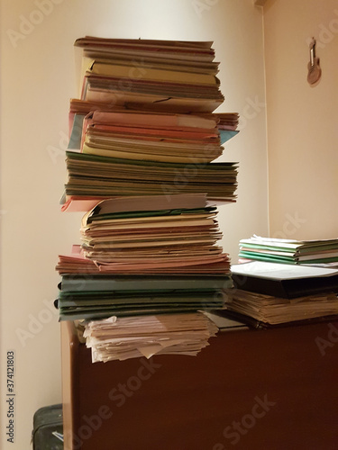 files folders pile in old dark office