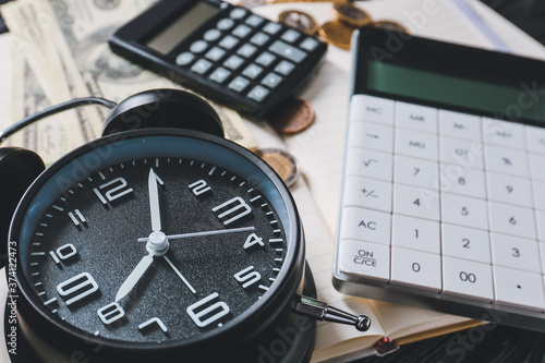 Alarm clock with calculators and money, closeup