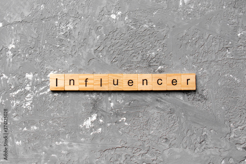 influencer word written on wood block. influencer text on table, concept