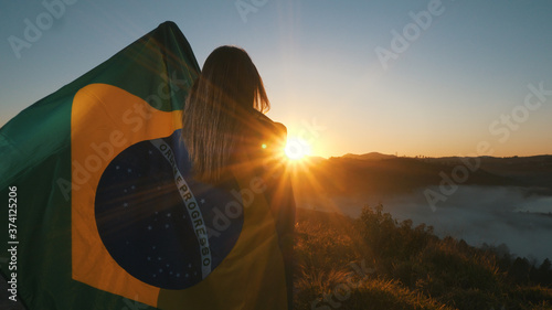 Brazilian Girl with National Flag at sunrise photo