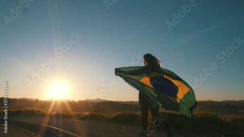 Brazilian Girl with National Flag at sunrise