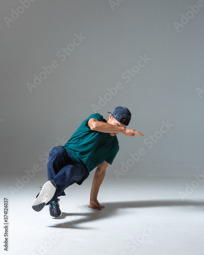 Cool guy breakdancer dancing lower break dance isolated on gray background. Breakdance poster