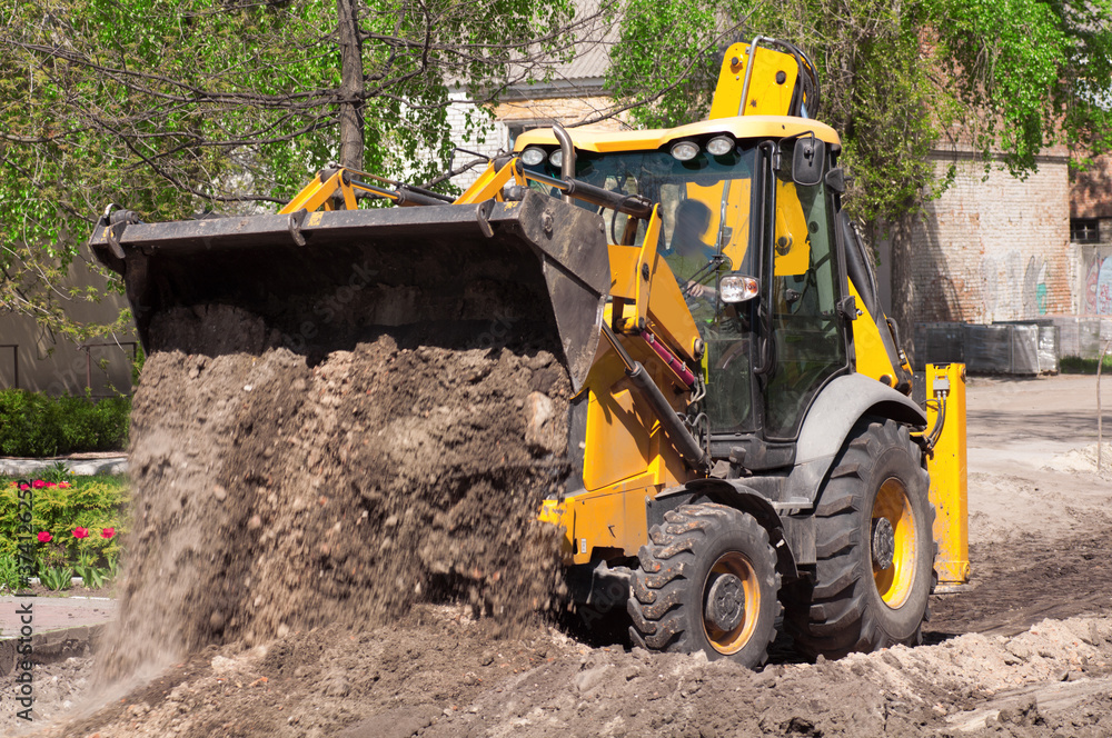 the tractor carries out excavation work in the construction the tractor carries out excavation work in the construction