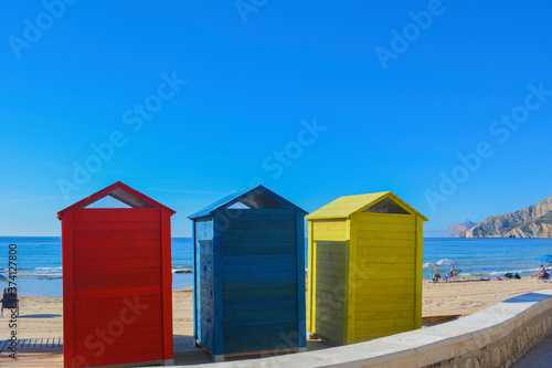 Three colourful beach huts on a sandy beach in Spain © Jub Jub Photography