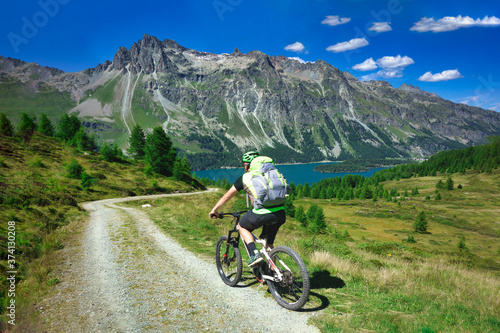 Biker on mountain dirt road in beautiful landscape on the alps © michelangeloop