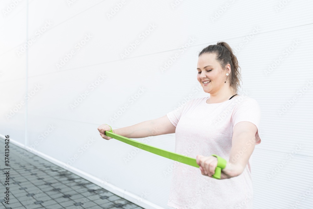 Fat woman exercising with resistance band Fat woman exercising with resistance band