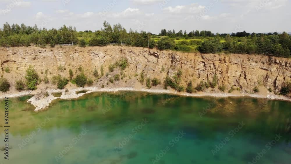 Blue lake in the center of the quarry.4K, UHD, Cinematic Blue lake in the center of the quarry.4K, UHD, Cinematic