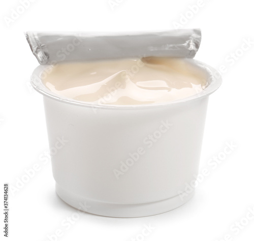 Plastic cup of tasty yogurt on white background