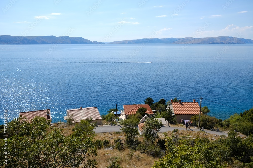 Beautiful view of Sveti Juraj, Croatia. A small quiet port village on the Adriatic with crystal clear water. View from viewpoint to rocky coast with houses by the sea.