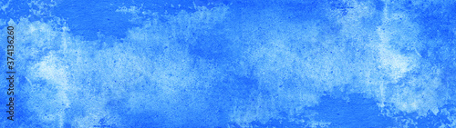 Abstract blue watercolor painted paper texture background banner wide panorama blue sky 
