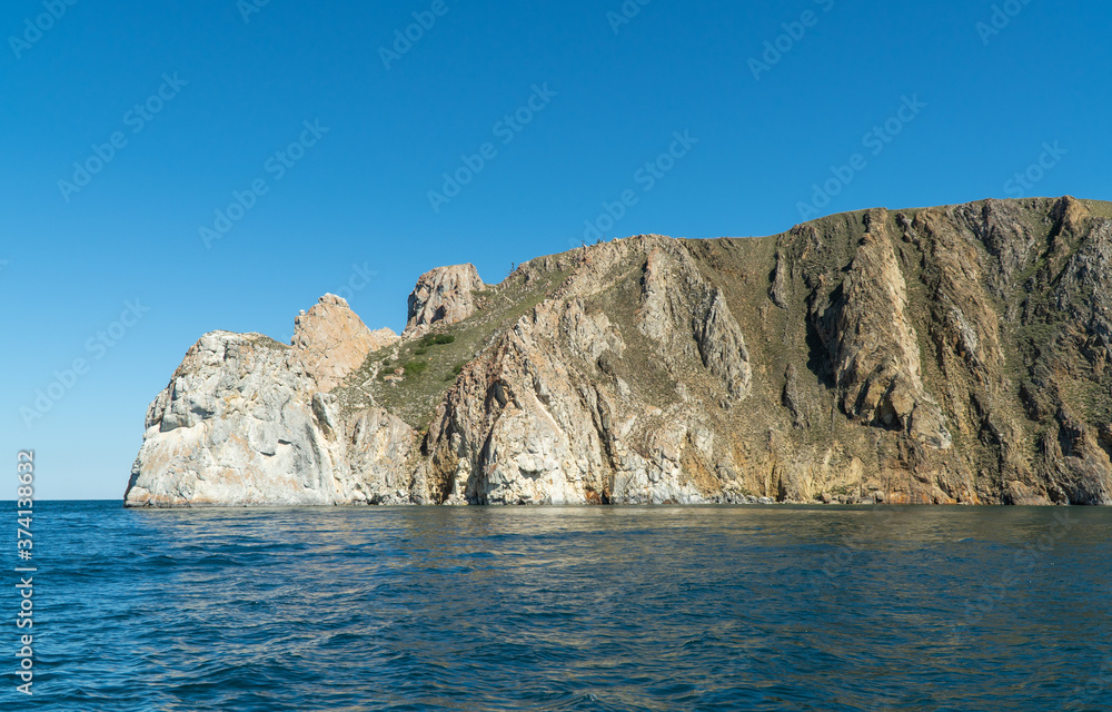 Cape Sagan-Khushun, rocky coast. called as the Cape Three brothers. Three stone peaks symbolizing the three brothers. Cape Sagan-Khushun, rocky coast. called as the Cape Three brothers. Three stone peaks symbolizing the three brothers.