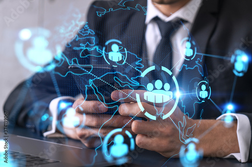 Businessman using on-line app on phone. social network icons hologram. Multiexposure. People connection concept.