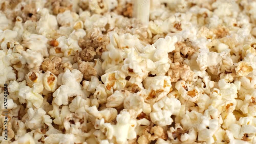 popcorn falling dow and rotating. pour popcorn close up popcorn falling dow and rotating. pour popcorn close up