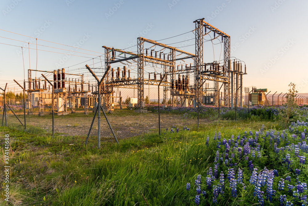 Fenced electricity substation in the countryside at sunset Fenced electricity substation in the countryside at sunset