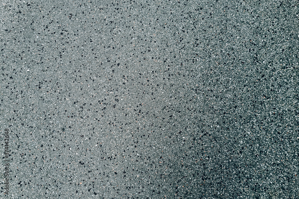 First raindrops on dry asphalt road