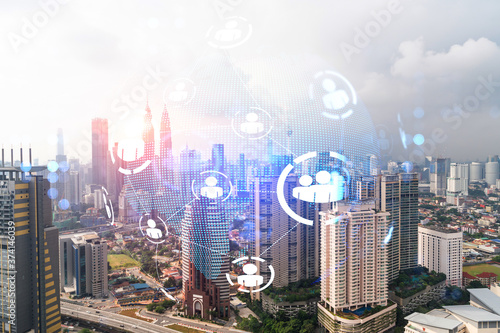 Social media icons hologram over panorama city view of Kuala Lumpur  Malaysia  Asia. The concept of people networking and connections. Double exposure.