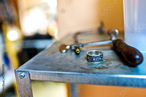 Close-up ring with silver-black design at jewelry workshop