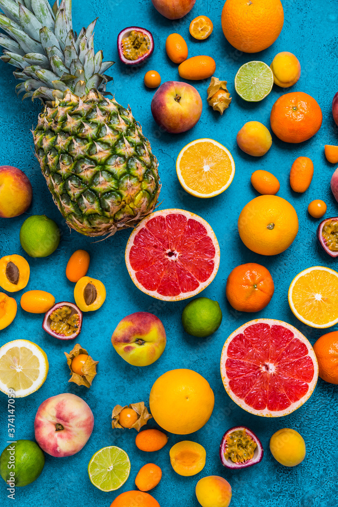 Flat lay layout of summer and citrus fruits on blue background Flat lay layout of summer and citrus fruits on blue background
