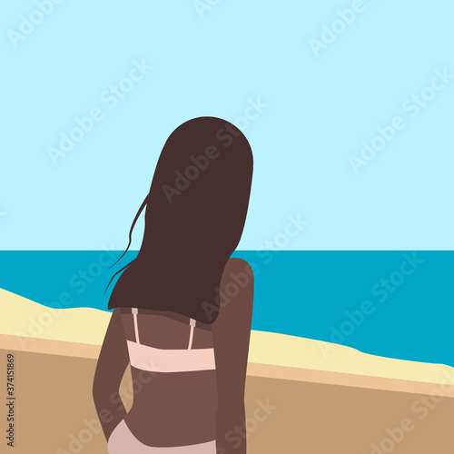 A tanned girl stands with her back to the shore and looks at the sea.