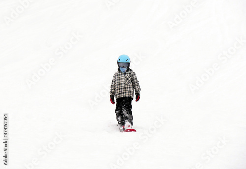 FEB 17, 2018 IWATE, JAPAN : Asian children snowboarder is riding with snowboard from powder snow hill
