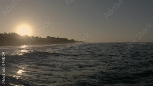 Hovering over the waves gently lapping against the shoreline in Marbella