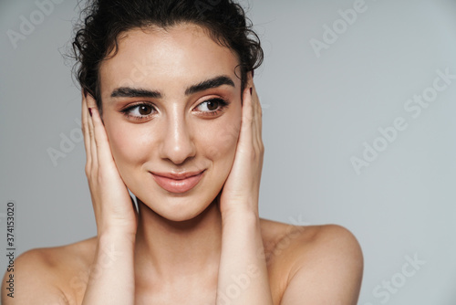 Image of half-naked woman looking at camera and covering her ears