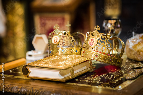 Two crowns for an orthodox wedding ceremony and a religious book for a wedding ceremony 