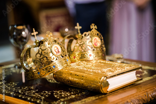 Obraz na plátně Two crowns for an orthodox wedding ceremony and a religious book for a wedding c