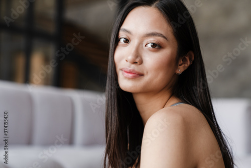 Free Download Image of pleased beautiful asian girl posing and looking at camera - GFXLoad