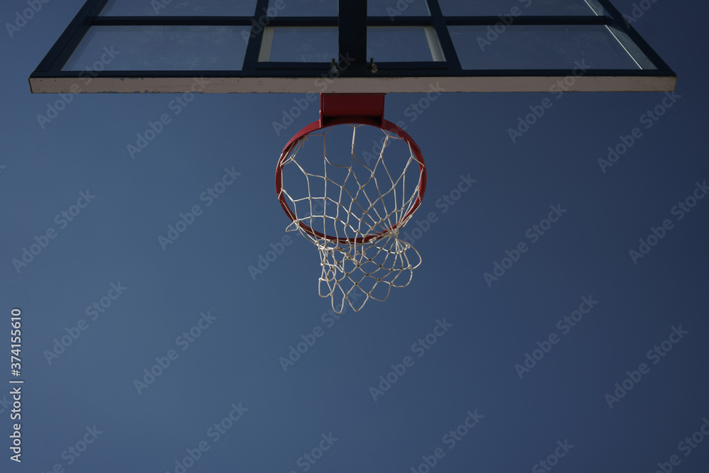 Image of basketball hoop on city sports ground at summer day