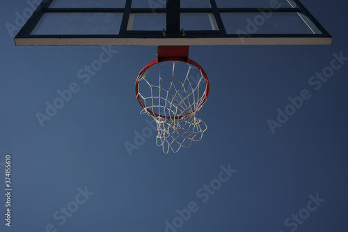 Image of basketball hoop on city sports ground at summer day © Drobot Dean