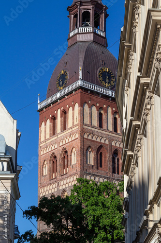Riga. Buildings and cozy streets of the old city. Variegated facades, stone paving stones. Cafes and restaurants. People walk the streets in the evening. Latvia. Summer 2020