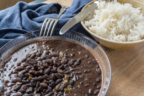 Traditional Cuban cuisine, black beans and rice in two clay bowls photo