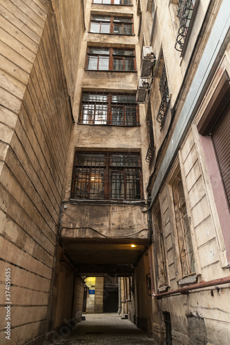 Arch in the entrance courtyard of an old apartment building in St. Petersburg