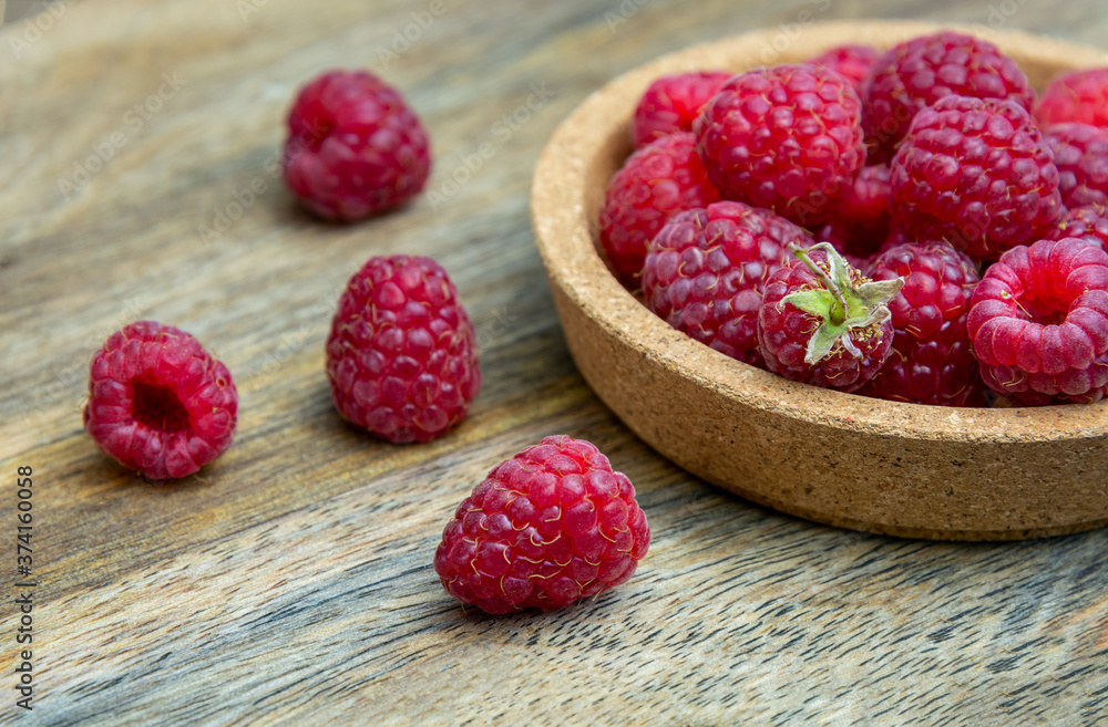 ripe raspberries on a wooden background. Selective focus. Rustic ripe raspberries on a wooden background. Selective focus. Rustic