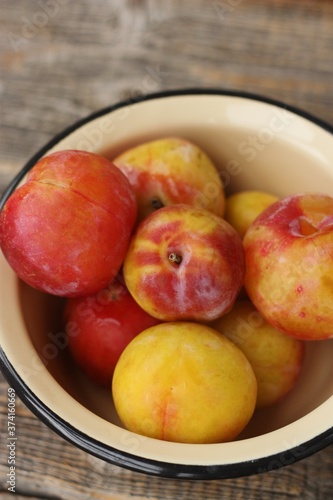Juicy seasonal plums on the table macro