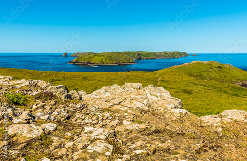 A view of Skomer Island (breeding ground for Atlantic Puffins) from Wooltack Bay on the mainland in early summer photo