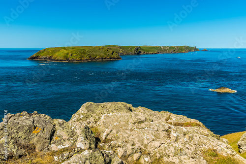 A view towards Skomer Island  breeding ground for Atlantic Puffins  from Wooltack Bay on the mainland in early summer