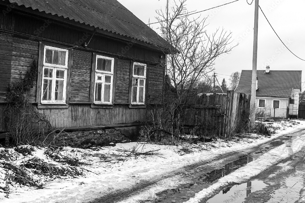 Russian village house next to a spring road