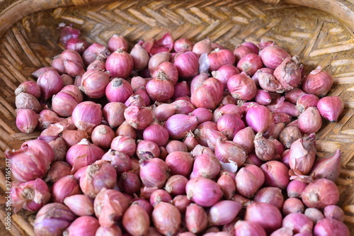 healthy shallots used for everyday cooking in a bamboo tray