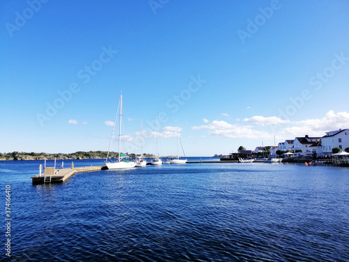 Closeup shot of multicolored boats in the water in Risor, Norway photo