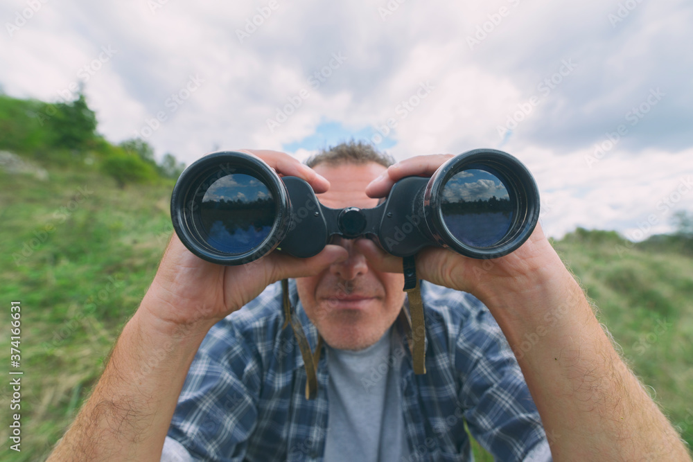 Man looking through binocular Man looking through binocular
